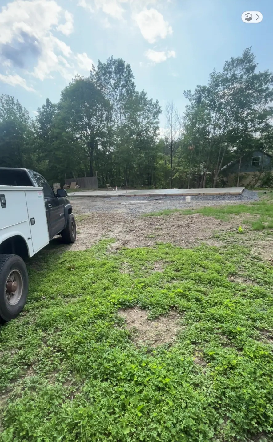 Poured concrete slab and prepped building site with NK Services service truck on site